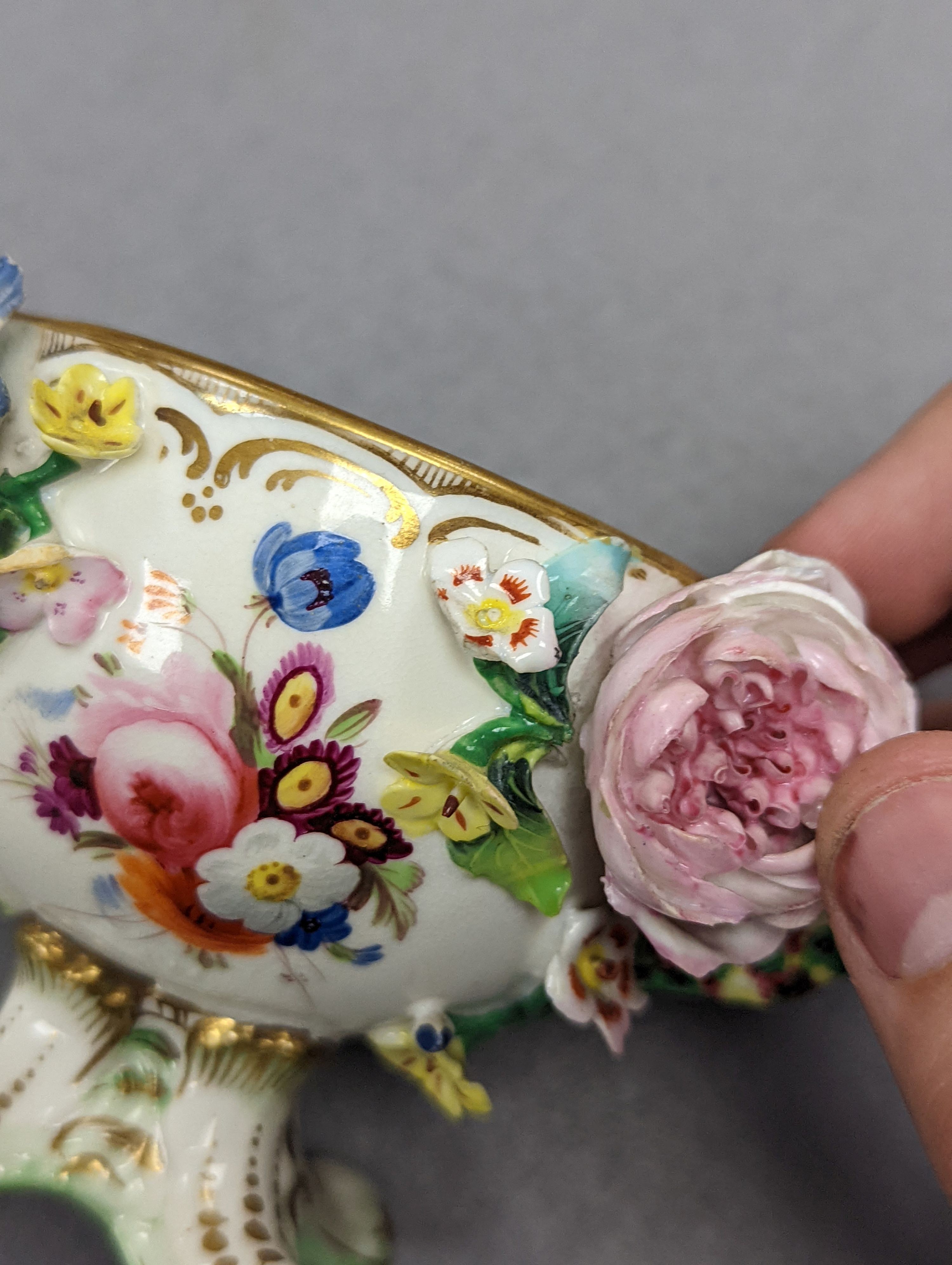 An 18th century Mennecy porcelain cup and cover, a Meissen style cup and cover, an English porcelain floral encrusted double inkwell and cover and a similar jar and cover